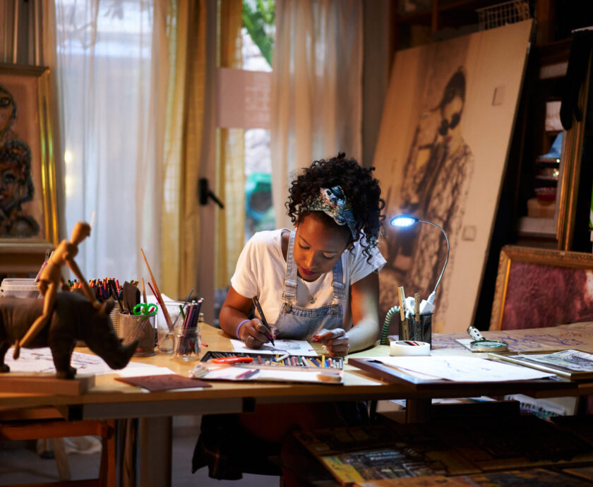 Young African-American artist at work in the studio. Creative person making art.